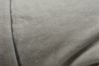 Macro close-up of Eden Home garment-washed polyester fabric texture in Odara neutral sand tone showing soft breathable fibers