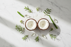 Fresh coconut halves panthenol vitamin B5 capsules and botanical leaves flat lay curl styling ingredients lifestyle photo