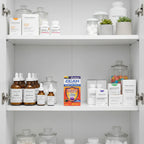 Zicam Cold Remedy Plus Elderberry box in organized medicine cabinet with white-label bottles and clear glass storage