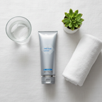SkinMedica TNS Body Lotion flat lay on white linen with towel plant and glass spa lifestyle