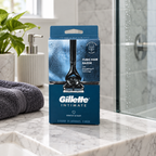 Gillette Intimate Pubic Hair Razor box on a bathroom marble countertop near a shower