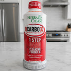 Detail-rich macro composition of Herbal Clean QCarbo32 red and white liquid wellness supplement bottle in modern kitchen setting