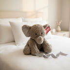 Russ Jazwares 21 inch Elephant Plush displayed as gift on white bedding with ribbon - More4less Outlet