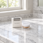 Rodan + Fields Enhancements Mineral Peptides box and jar on a marble bathroom vanity