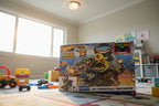 Hot Wheels Monster Trucks Arena Smashers playset box in child's play space with bright lighting