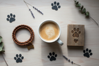 White ceramic mug and rustic wooden sentiment block flat lay with paw print decorations lifestyle photo