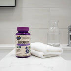 Garden of Life Elderberry Gummies bottle on bathroom quartz vanity with white cotton face towel and aesthetic glass water carafe