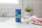 Mommy's Bliss Baby Probiotic Drops Vitamin D box on white marble bathroom counter with dropper and pink baby washcloth - More4less Outlet