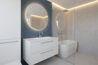 Modern minimalist bathroom with polished chrome faucet on white vanity, blue accent wall and round mirror