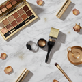Mary Kay Gel Liner Duo Dramatic Gold glamorous makeup vanity flatlay with gold accents and luxury beauty accessories