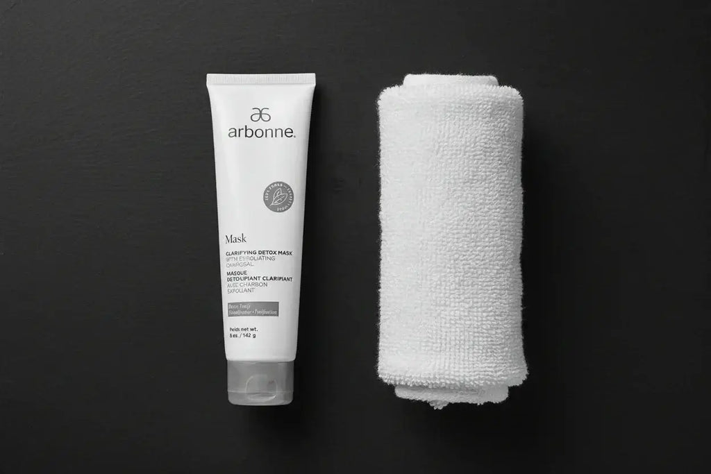 Arbonne Clarifying Detox Mask 5 oz tube flat lay with white towel on dark background - More4less Outlet