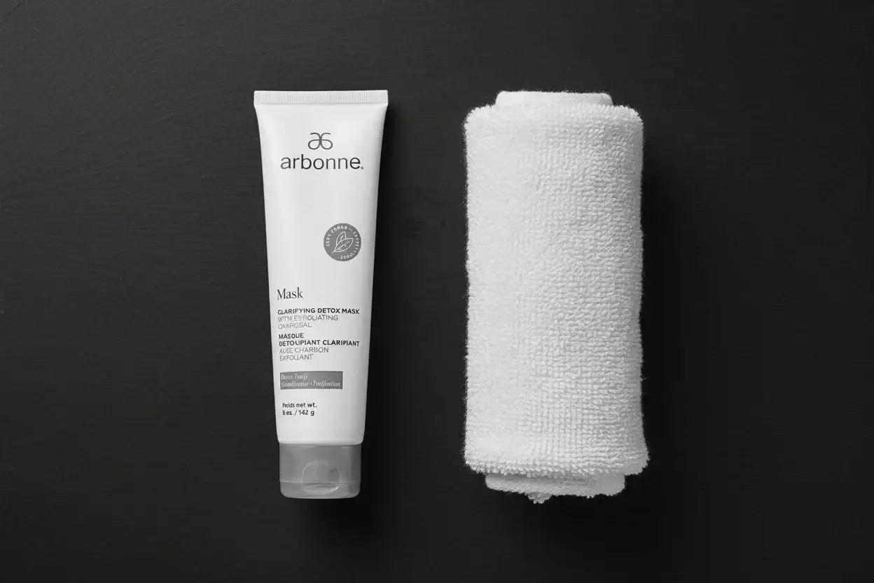Arbonne Clarifying Detox Mask 5 oz tube flat lay with white towel on dark background - More4less Outlet