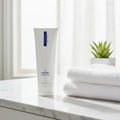 ZO Medical Oilacleanse cleanser on white marble bathroom vanity with soft morning sunlight spa aesthetic