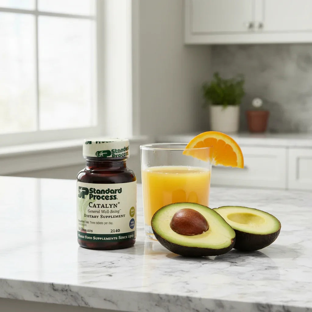 Standard Process Catalyn on morning breakfast counter with orange juice and avocado highlighting whole food nutrition