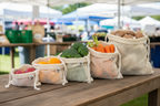 SuperBee organic cotton mesh produce bags set of 5 filled with colorful fresh produce on farmers market table