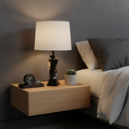 Minimalist nightstand setup with black geometric twisted lamp base and white linen shade in modern bedroom