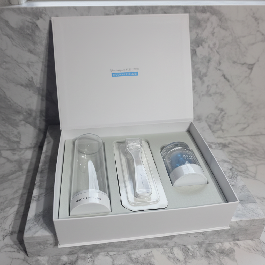 Rodan and Fields REDEFINE AMP MD System open white luxury box with derma-roller serum capsule container and cleansing vial on white marble vanity – More4less Outlet