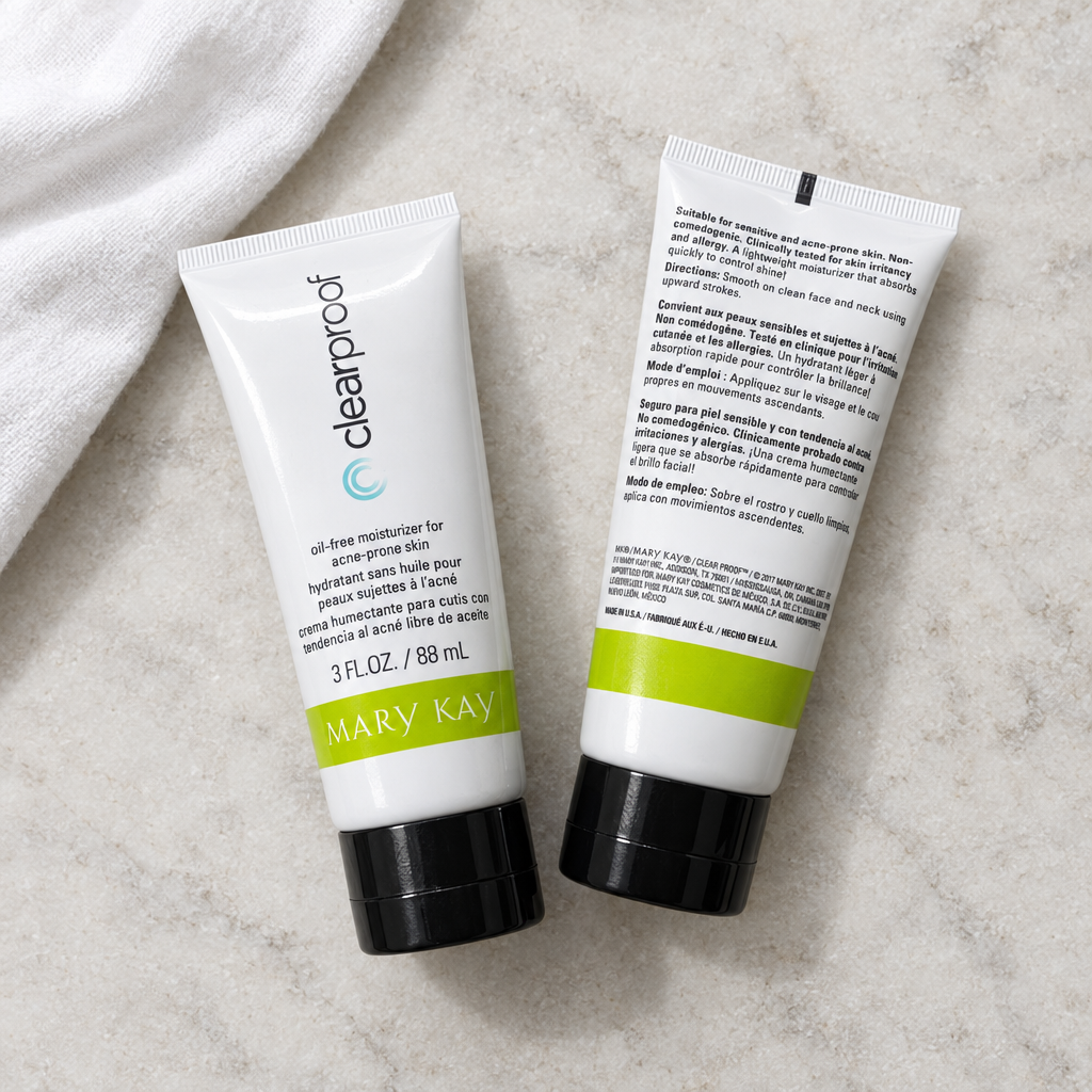 Two Mary Kay Clear Proof Oil-Free Moisturizer tubes arranged on a pale stone surface
