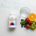 GNC Women's Multivitamin Energy & Metabolism bottle on marble with fruit and water – More4less Outlet