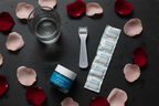 Rodan + Fields micro-roller and serum capsules dark slate beauty flatlay - More4less Outlet