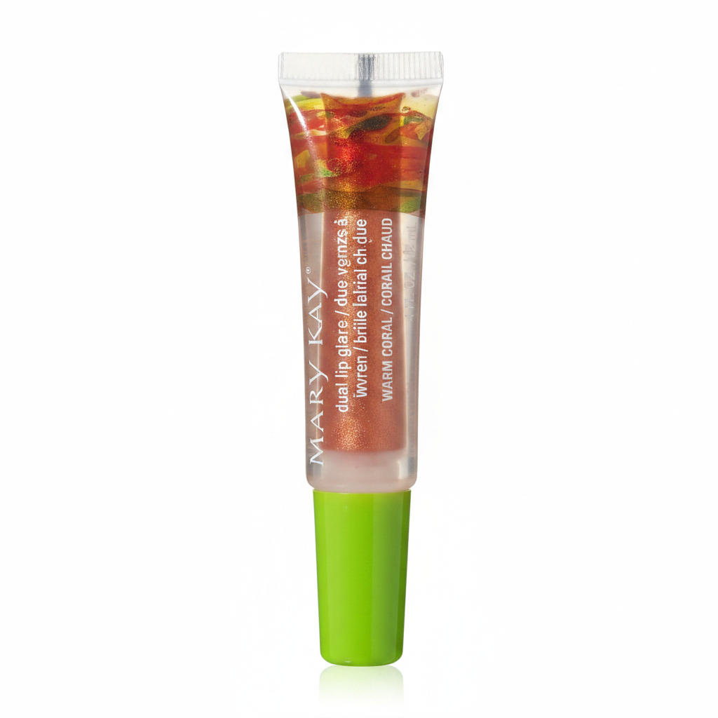 Close-up macro of Mary Kay Dual Lip Glaze Warm Coral — clear dual-chamber squeeze tube with green cap showing metallic coral-gold shimmer pigment core separated from clear gloss outer chamber on a white background