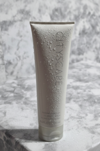 Mary Kay Cityscape Silkening Shower Gel with sparkling water droplets on white marble surface
