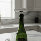 Close-up of OXO SoftWorks vacuum wine stopper inserted into wine bottle on marble surface preserving freshness