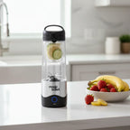 Magic Bullet Portable Blender on white quartz kitchen island with fresh fruit bowl of bananas and strawberries for natural smoothies