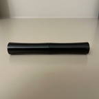 vanity-context view of a black Mary Kay Lash Love Mascara tube
