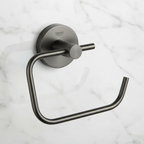 Grohe Essentials Hard Graphite toilet paper holder close-up showing dark graphite metallic finish and concealed round disc wall mount