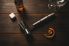 Houdini Double Jigger close-up flatlay on dark wood with bitters orange peel and coupe glass - More4less Outlet