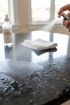Spray nozzle misting sparkling clean granite countertop surface