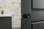 Kwikset Arroyo matte black dummy knob on charcoal pantry door in modern kitchen with white shaker cabinets - More4less Outlet