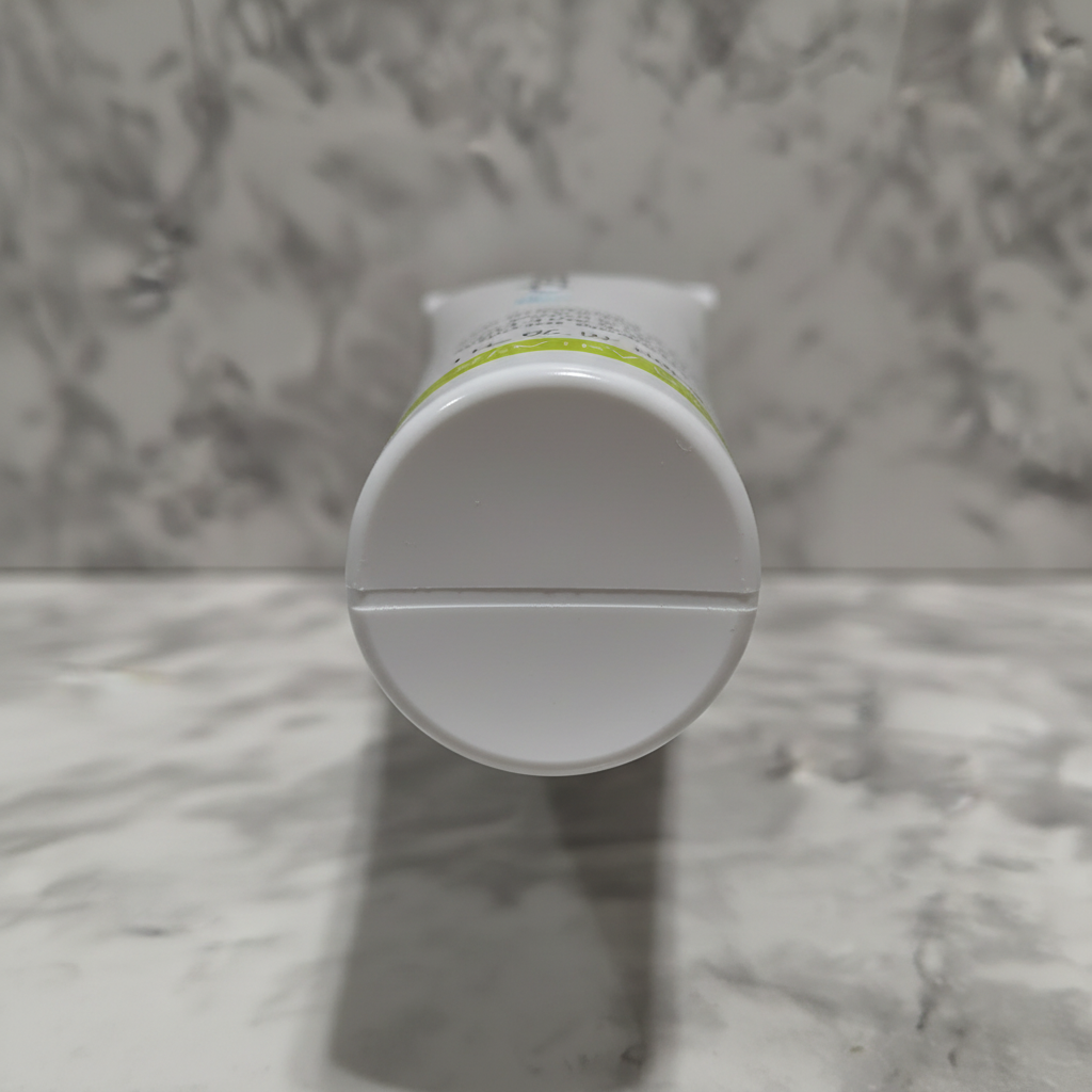 Macro shot of clean stamp-free crimped bottom of Mary Kay Clear Proof moisturizer tube