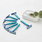 Gillette Sensor2 Plus blue razors fanned out on white surface with ceramic soap dish and eucalyptus sprig – More4less Outlet