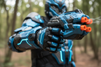 Close-up hero shot of Gelbee Flurry Glove mecha gel BB blaster aimed forward with dramatic outdoor background — More4less Outlet