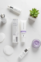 Rodan and Fields UNBLEMISH Invisible Matte Defense SPF 30 tube flat lay on white surface with purple skincare props and cotton pads – More4less Outlet