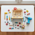 Hape Little Engineer's Workbench wooden toy set open on white playroom table with soft natural light – More4less Outlet