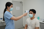 Healthcare provider using Wiselion non-contact infrared thermometer to check forehead temperature at 3-5cm distance
