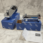 Grohe Lineare tub spout with diverter flat lay on white marble with original Grohe blue retail box and installation manual