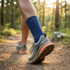 Runner with ankle compression sleeve on trail, close up of ankle during outdoor active recovery