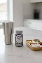 Centrum Men 50+ MultiGummies bottle on white marble breakfast island with stainless tumbler and supplement tray