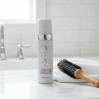 Hair volumizer foam pump bottle beside round brush and white towel on white marble bathroom counter – More4less Outlet