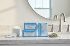 Clean white bathroom vanity with light blue Rodan + Fields Redefine Eye Cloths package