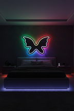 Melannco butterfly shaped LED mirror glowing with colorful RGB lighting in dark modern bedroom