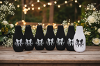 Lady and Home bridal party bottle sleeves set of 7 displayed on rustic wooden table with wedding greenery flowers and string lights
