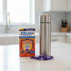 Zicam Cold Remedy Plus Elderberry box on white quartz breakfast island with stainless steel thermal flask and wrapped lozenges