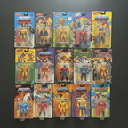 Flat lay overhead shot of retro 80s action figure collectibles in original blister card packaging on dark matte surface — More4less Outlet
