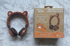Planet Buddies Charlie the Tiger furry wired headphones and retail box displayed on clean white marble surface