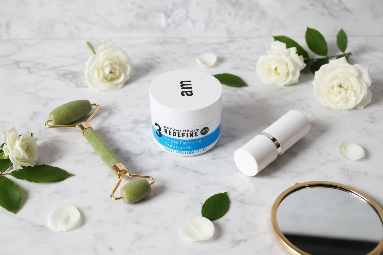 Rodan + Fields REDEFINE Triple Defense Treatment SPF 30 AM jar morning flat lay with jade roller white flowers and mirror on marble – More4less Outlet